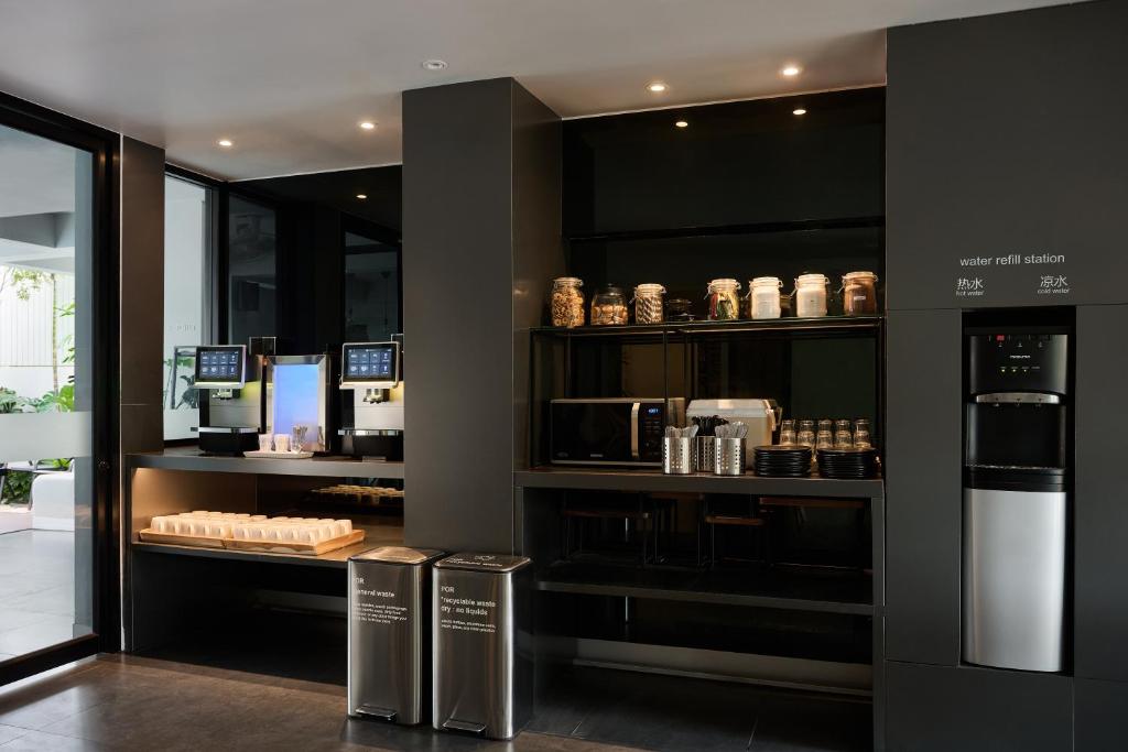 A self-service food and drink station with packaged items and a dispenser.