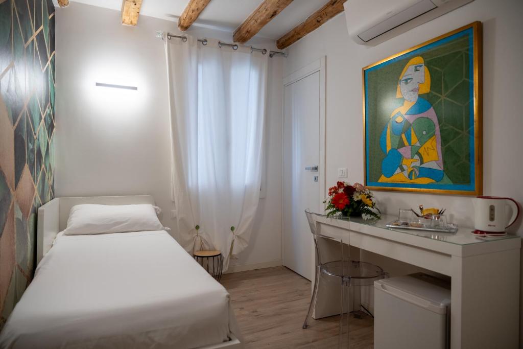 Postel nebo postele na pokoji v ubytování Hermes Venice