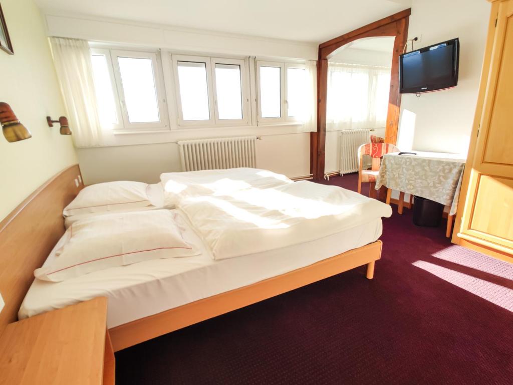 Postel nebo postele na pokoji v ubytování Hôtel Restaurant Roess