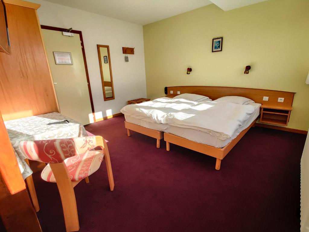 Postel nebo postele na pokoji v ubytování Hôtel Restaurant Roess