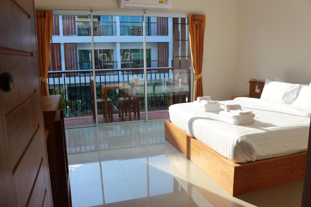 a bedroom with a bed and a large window at Crystal Lamai Hotel in Lamai