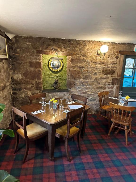 a dining room with a wooden table and chairs at The Red Admiral Gosforth CA20 1BP in Seascale