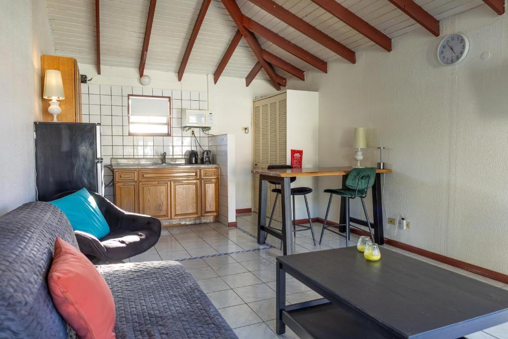 a living room with a couch and a table at Talk of the Town Inn & Suites - St Eustatius in Oranjestad