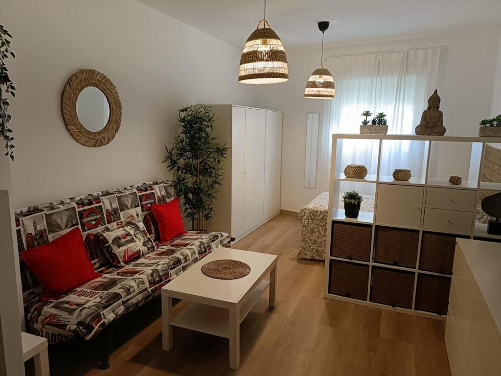 a living room with a couch and a table at Estudio Don Angel in Camas