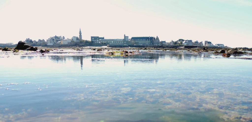 a body of water with a city in the background at Hôtel Aux Tamaris - Vue Mer in Roscoff