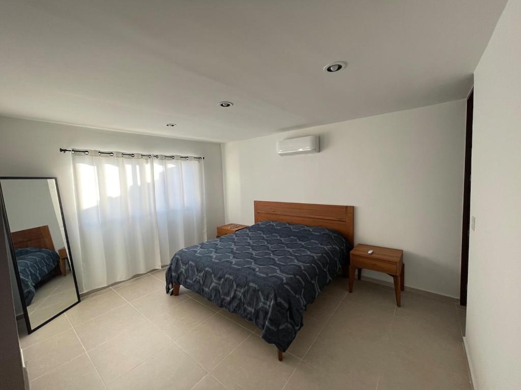 Postel nebo postele na pokoji v ubytování Itzamná House