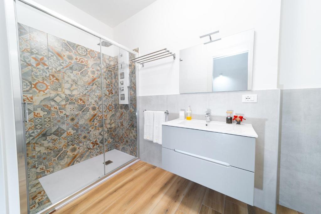 a bathroom with a shower and a sink and a mirror at La dimora di via Umberto-private bathrooms in Catania