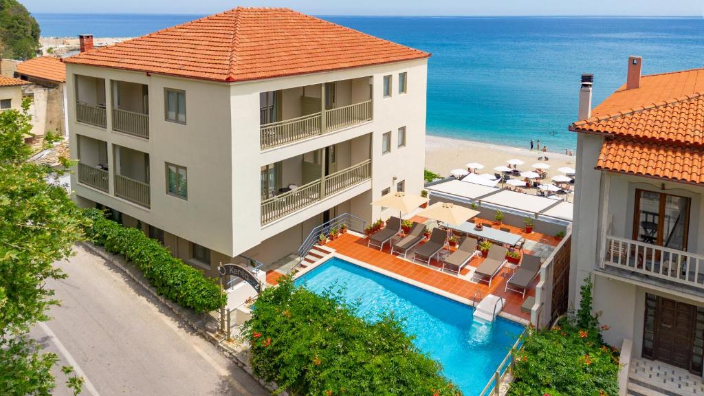 an aerial view of a resort with a swimming pool and the ocean at Kenta Beach Hotel in Agios Ioannis Pelio