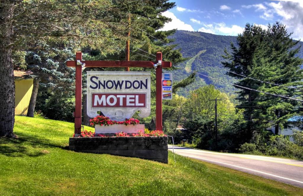 a sign for a snowdon motel on the side of a road at Snowdon Chalet Motel in Londonderry