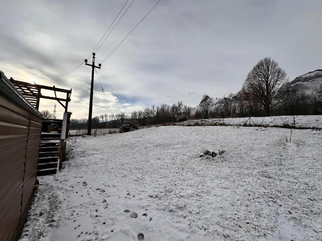 a snowy field with footprints in the snow at La Souste appartement avec jardin privatif in La Fare-en-Champsaur