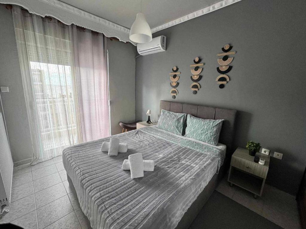 a bedroom with a large bed with towels on it at Sunset Sea Apartment in Alexandroupoli