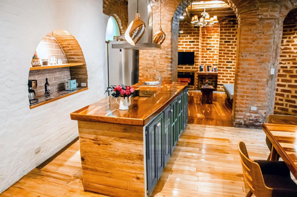 a kitchen with an island with a counter top at Old Town Quito Suites, Heritage Boutique Hotel, Where Every Detail Tells a Story in Quito
