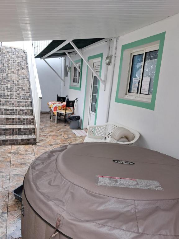 a house with a large table in the middle of a room at VILLA AU COEUR DE LA MARMITE in Sainte-Marie