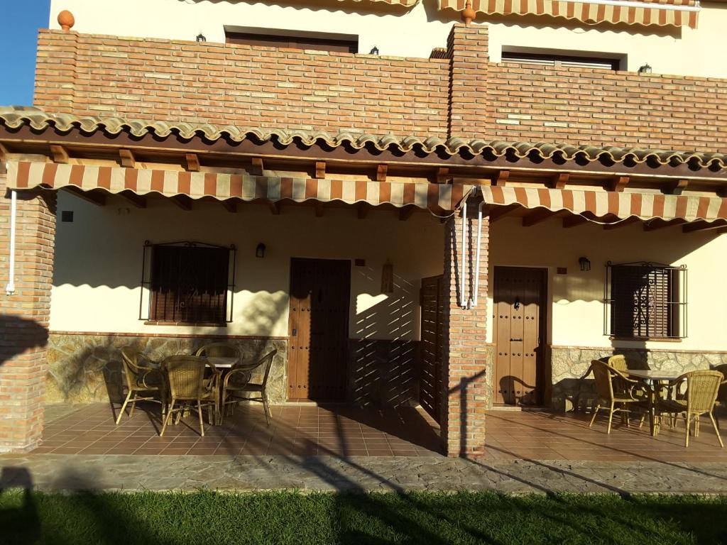 a patio of a house with chairs and a table at Residencial La Teja in Zahora
