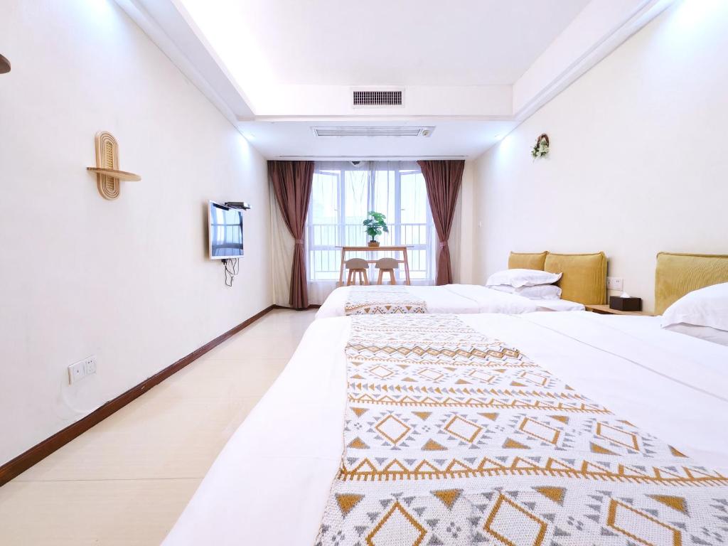 Voodi või voodid majutusasutuse Guangzhou Uhome Service Apartment toas