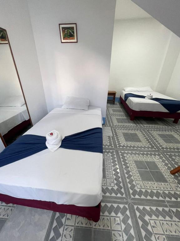 Postel nebo postele na pokoji v ubytování Hostal Gardner