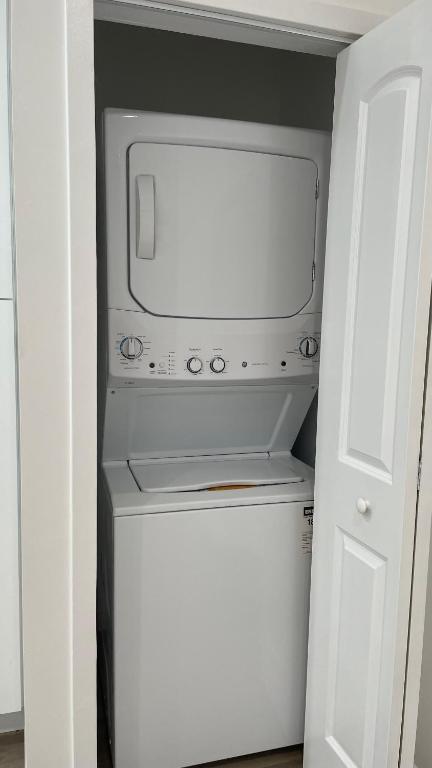 a microwave in a closet with a white door at Luxury mini house in Hughes-Canoga Park Heliport