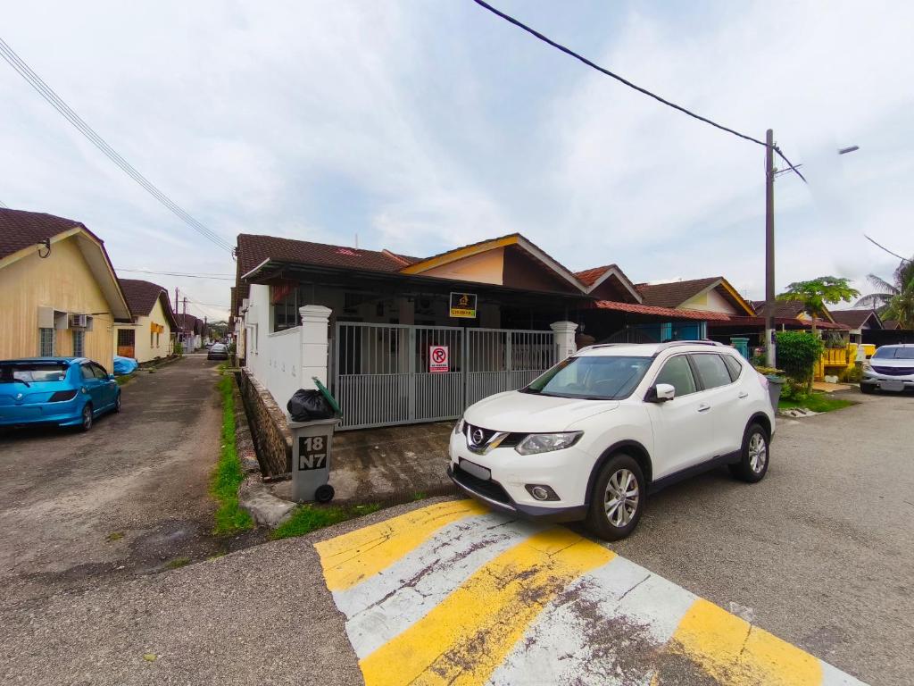 a white car parked in front of a house at Orchid Homestay Pasir Gudang in Pasir Gudang