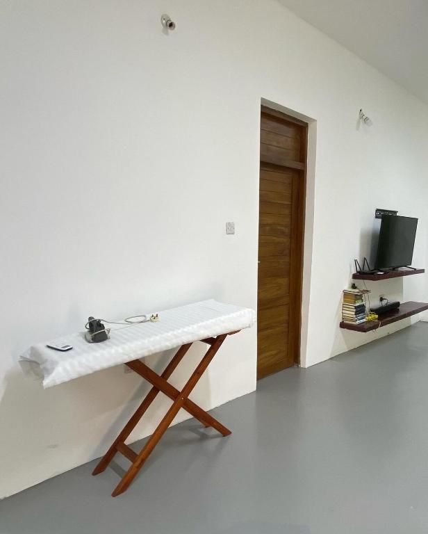 a white table in a room with a television at Mani Villas in Bungi