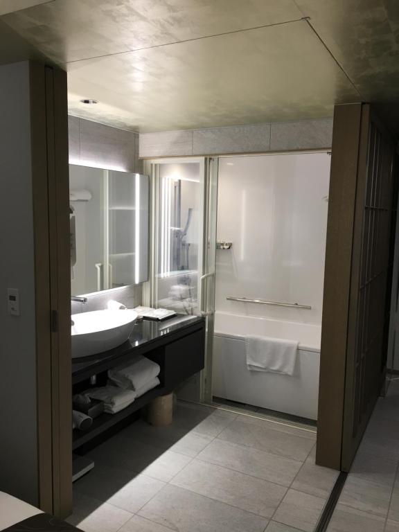a bathroom with a sink and a tub and a toilet at ANA Crowne Plaza Hotel Kyoto by IHG in Kyoto