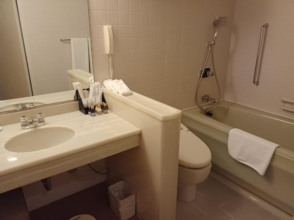 a bathroom with a sink and a toilet and a tub at ANA Crowne Plaza Hotel Kyoto by IHG in Kyoto