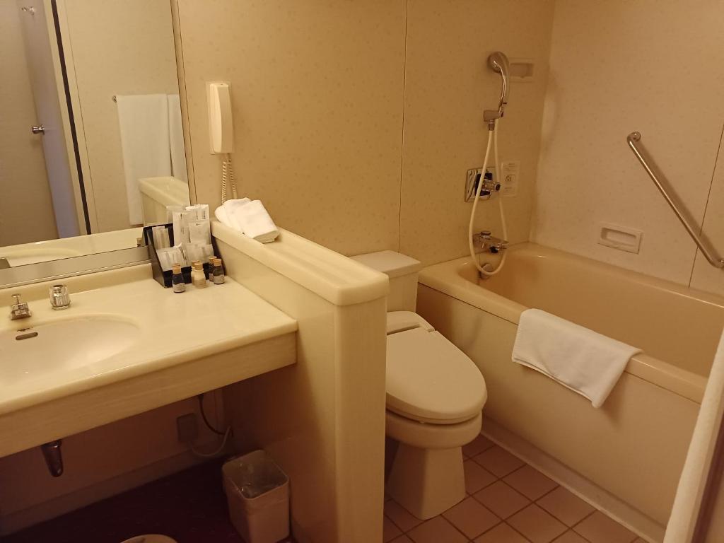 a bathroom with a toilet and a sink and a tub at ANA Crowne Plaza Hotel Kyoto by IHG in Kyoto