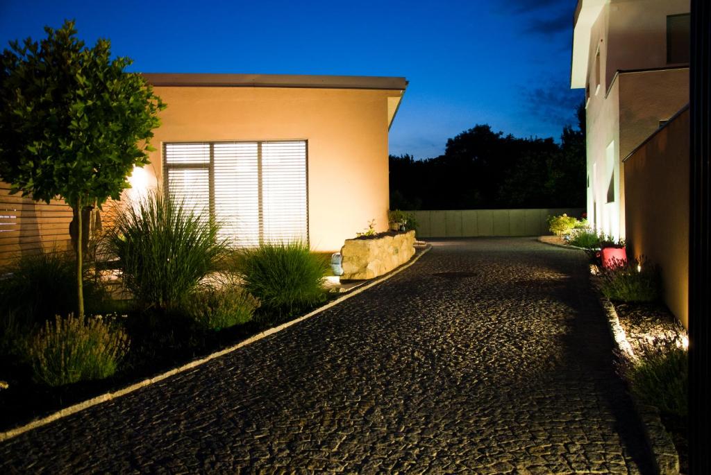 a driveway in front of a house at night at SALITEREI Ferienhaus im Herzen des Seewinkels in Frauenkirchen