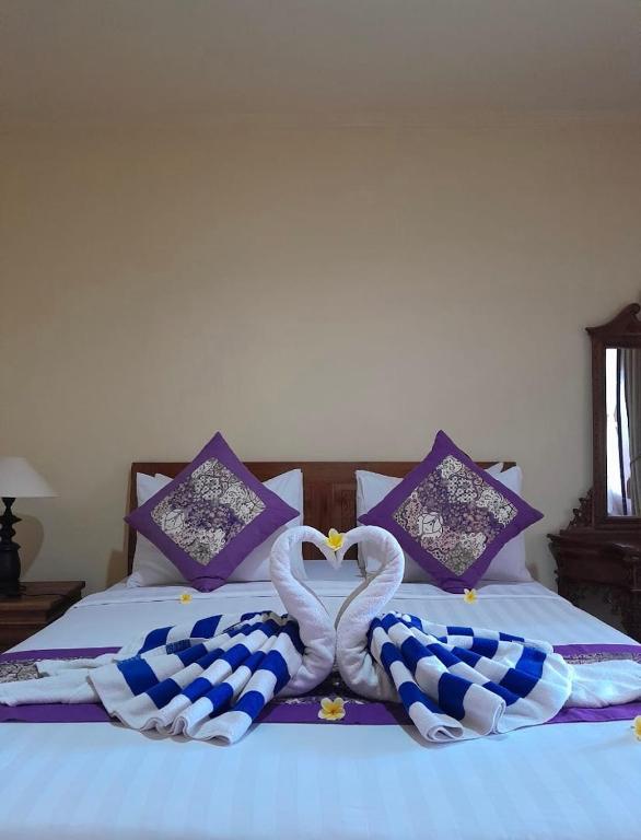 Postel nebo postele na pokoji v ubytování Ariartha homestay