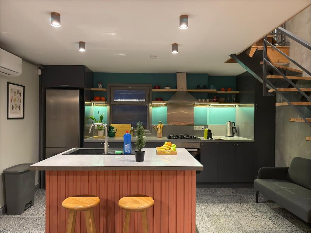 a kitchen with a kitchen island with two stools at Stunning Private House in Balat in Istanbul