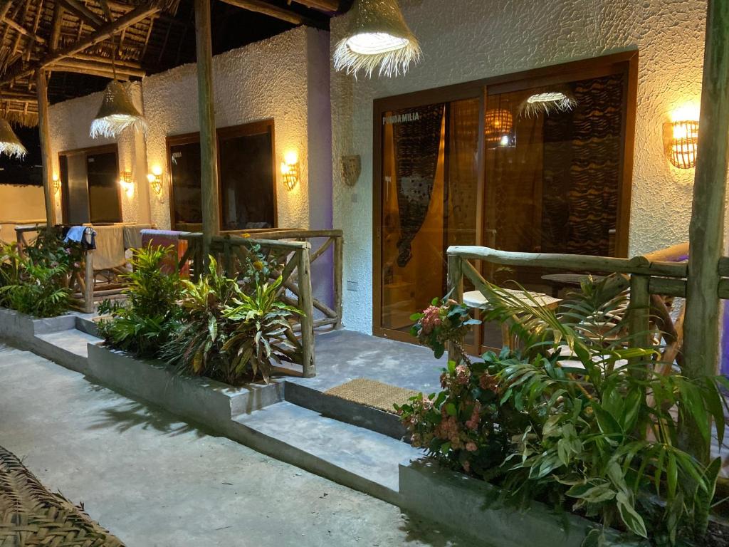 a lobby of a resort with plants and a porch at BOUGAIN VILLA -nice for couple in Nungwi