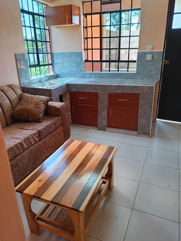 a living room with a couch and a coffee table at The Peak Meadows Hotel in Nyeri