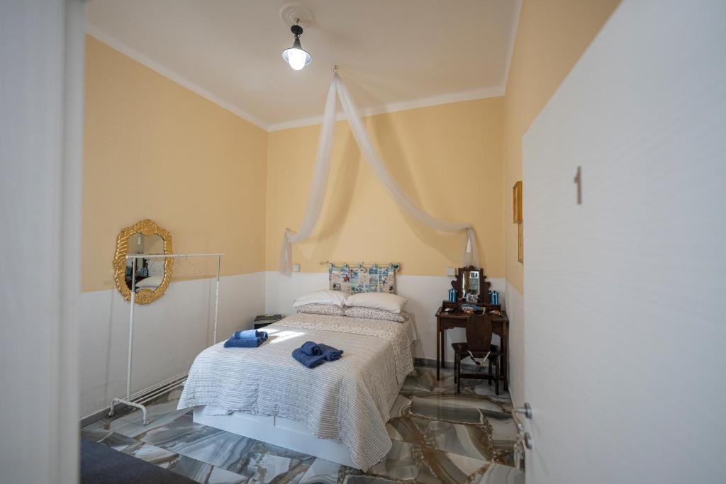 a bedroom with a bed and a table in it at lighthouse flat in Taranto