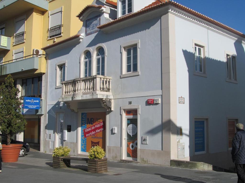 a blue and white building on a city street at CasAzulApartments in Sintra