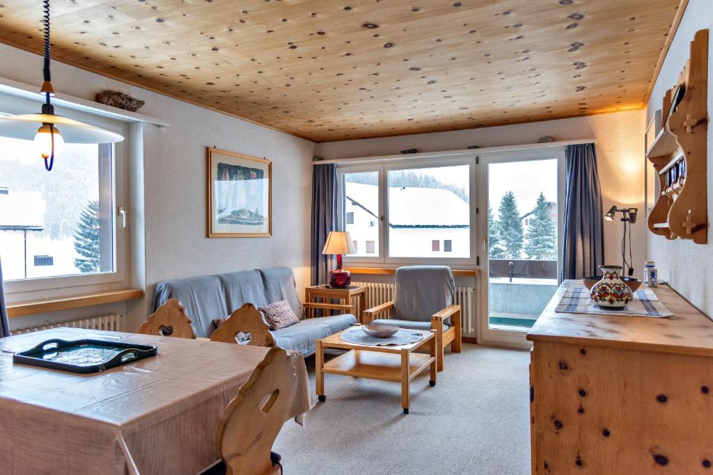 a living room with a couch and a table at Chesa Allegria - Sils Maria in Sils Maria