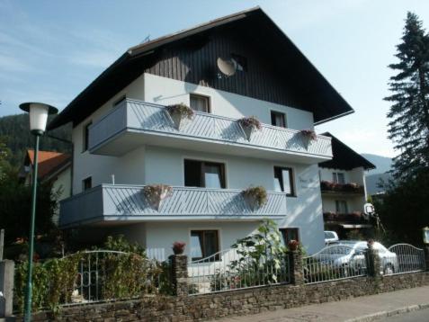 a large white building with a black roof at Haus Marisa Ferienwohnungen in Aflenz Kurort