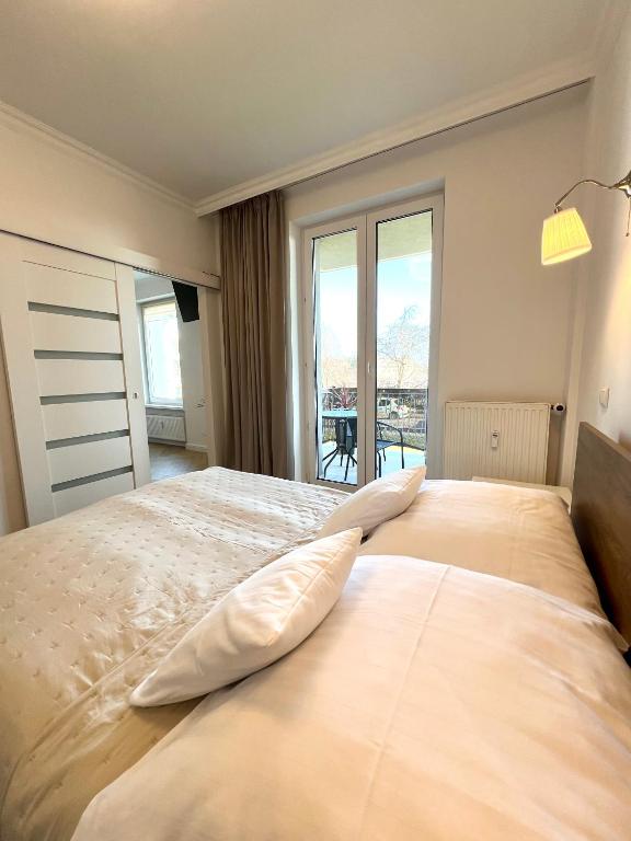 Łóżko lub łóżka w pokoju w obiekcie Apartamenty 19