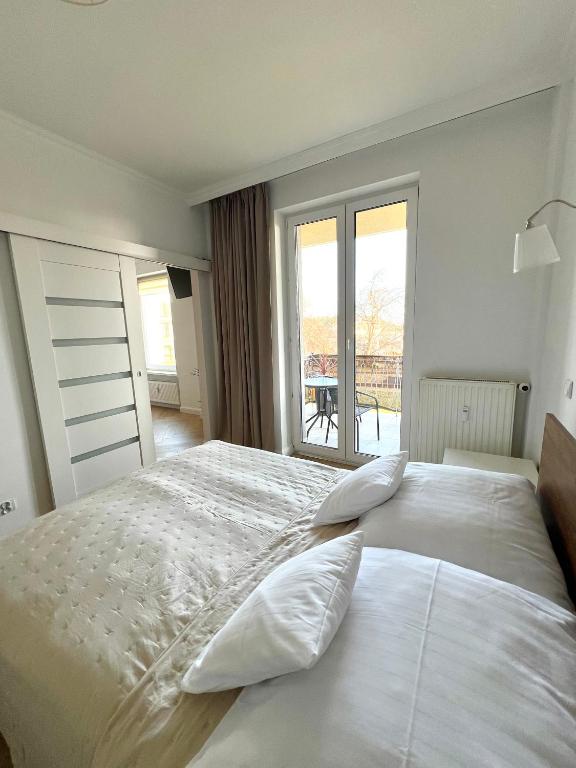 Łóżko lub łóżka w pokoju w obiekcie Apartamenty 19