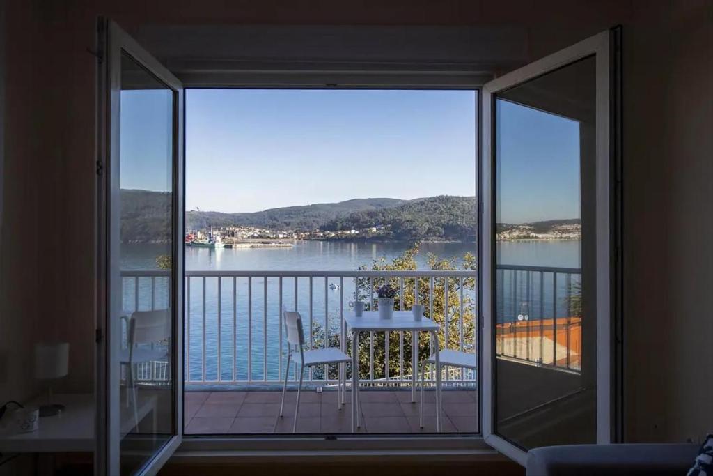 a view of a balcony with a view of the water at Apartamento Playa de Quenxe in Corcubión