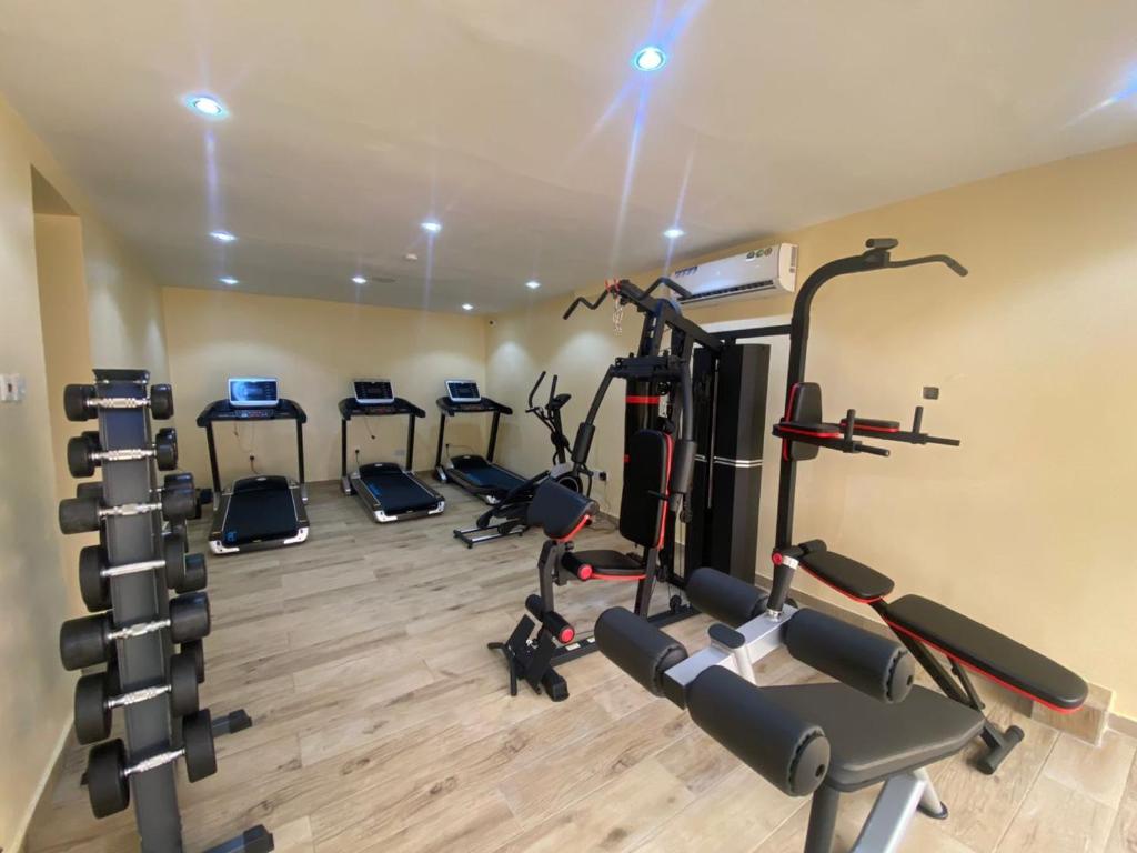 a gym with several tread machines in a room at Shortlet spaces in Lekki