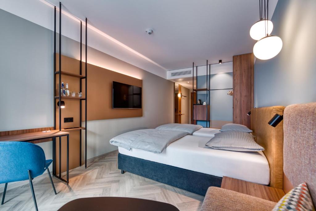 Postel nebo postele na pokoji v ubytování Stadthotel Neumarkt Mitte