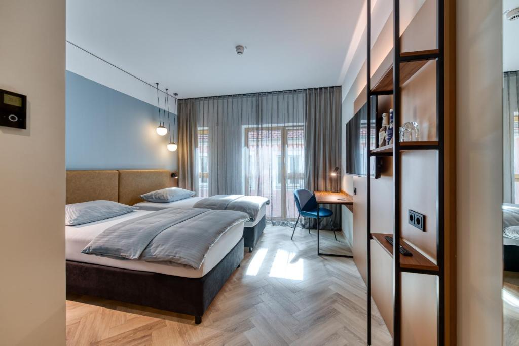Postel nebo postele na pokoji v ubytování Stadthotel Neumarkt Mitte