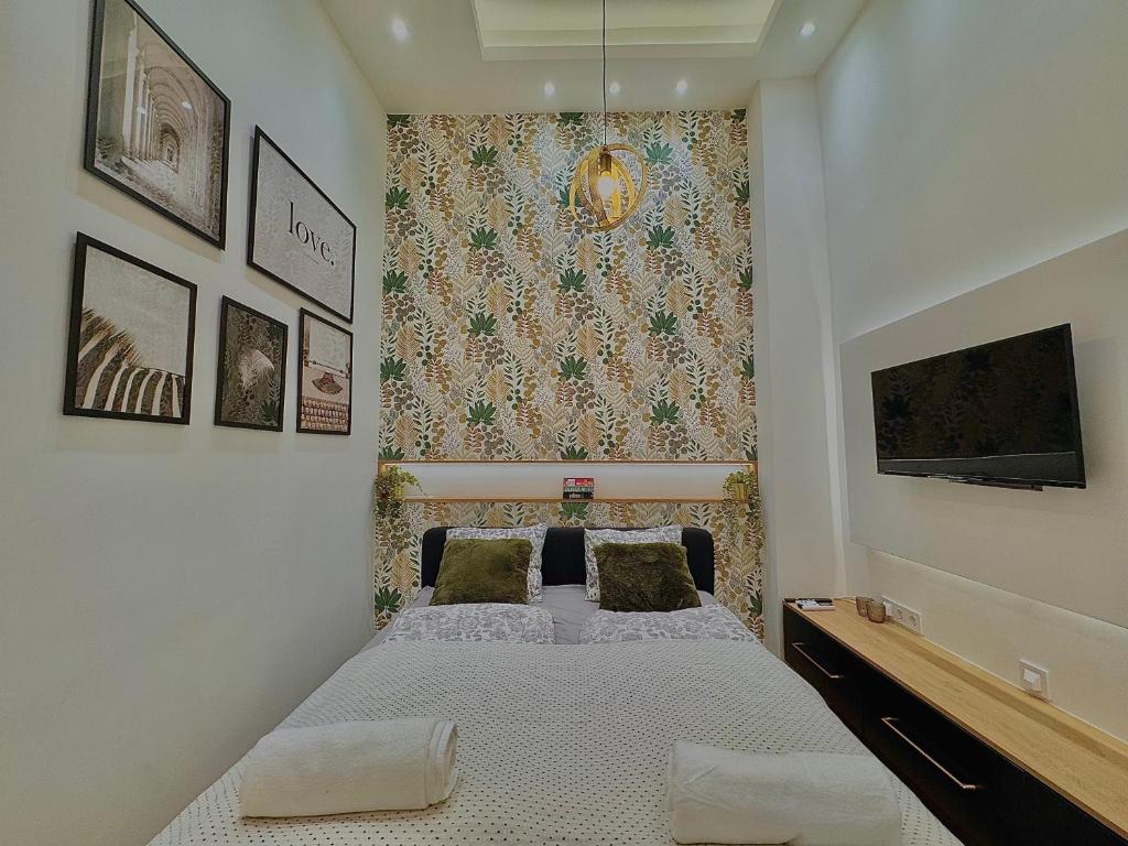 a bedroom with a bed with two pillows on it at The Pest Garden Condo A in Budapest