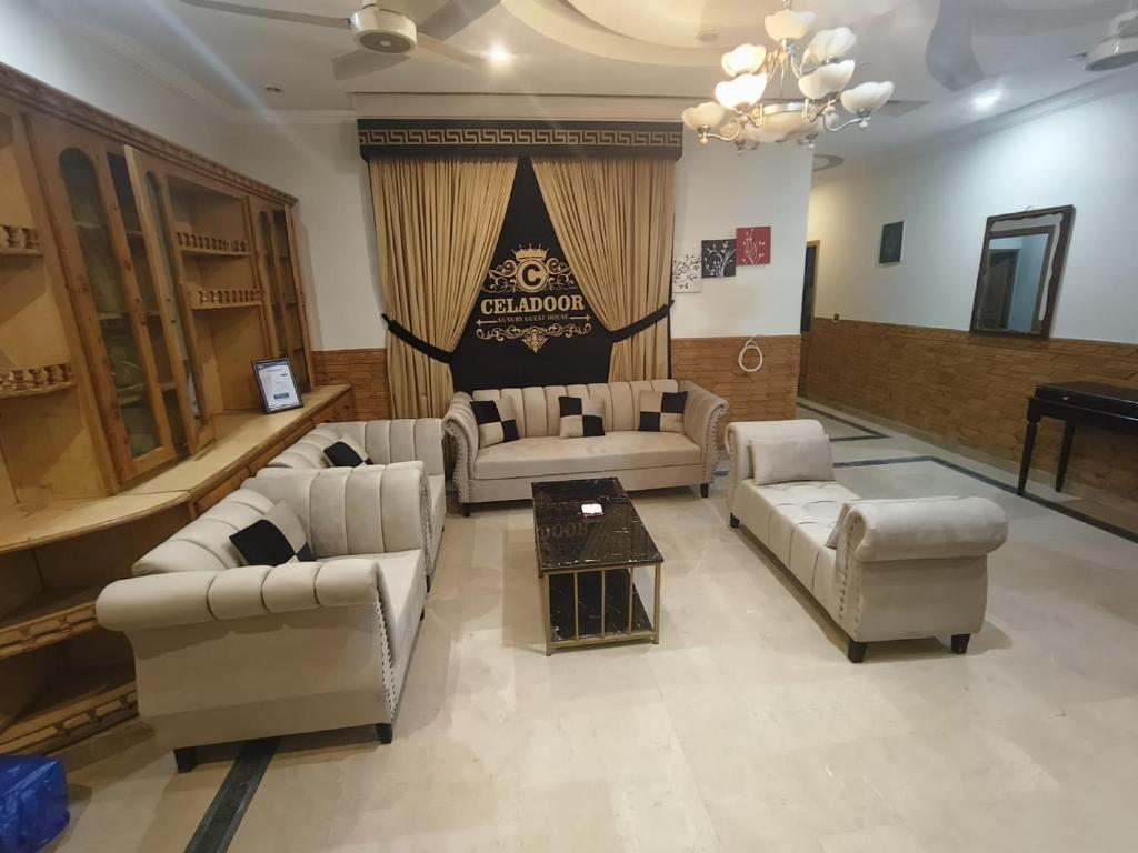 a living room with couches and chairs and a table at Family Guest House Islamabad in Islamabad