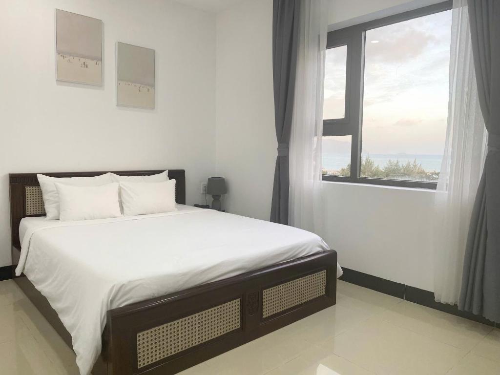 Postel nebo postele na pokoji v ubytování Horizon Côn Đảo Hotel