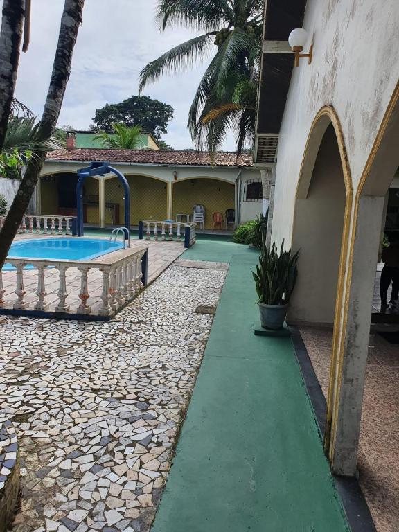 a resort with a swimming pool and a building at Aconchego do Viana in Belém