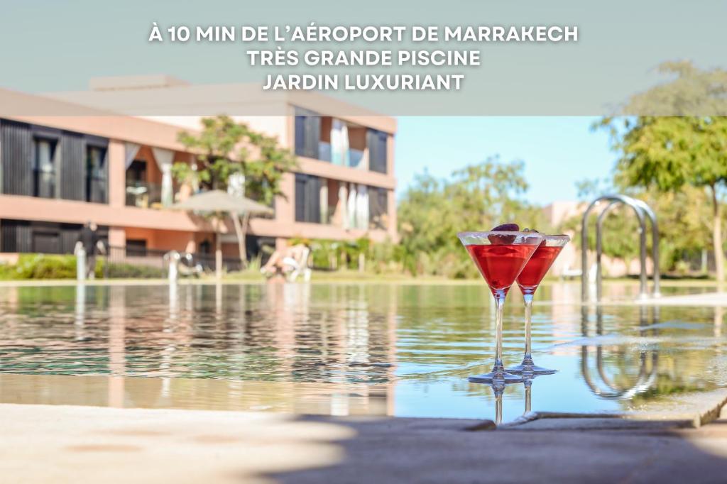 a martini glass sitting in the water next to a fountain at Ana cosy - Clim, Wifi, Jardin à 10min de l'Aéroport in Marrakech