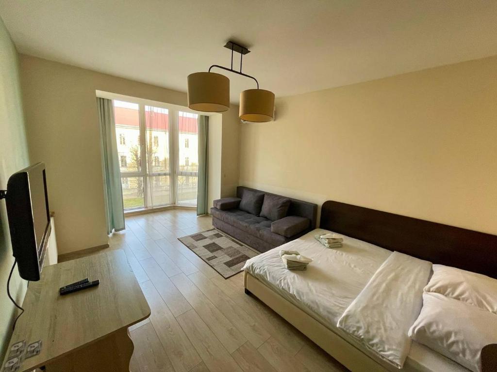 a living room with a bed and a couch at HotelRoom 32 in Uzhhorod