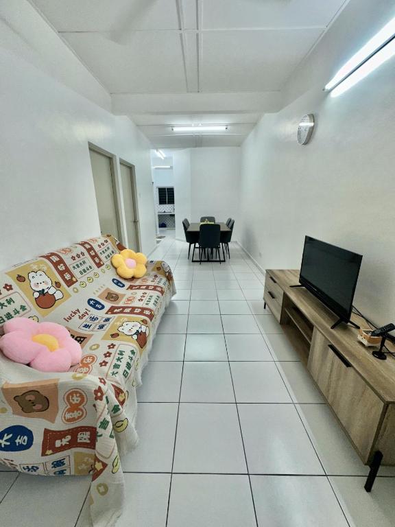a room with two beds and a flat screen tv at Urban Eats Stay in Ipoh