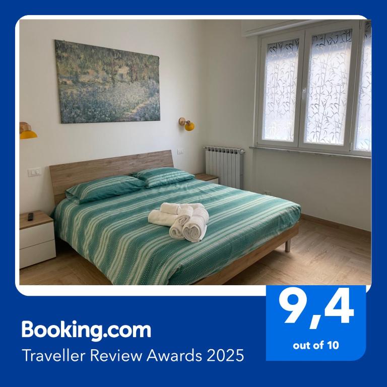 a bedroom with a bed with towels on it at LA CASETTA AL MARE in Savona