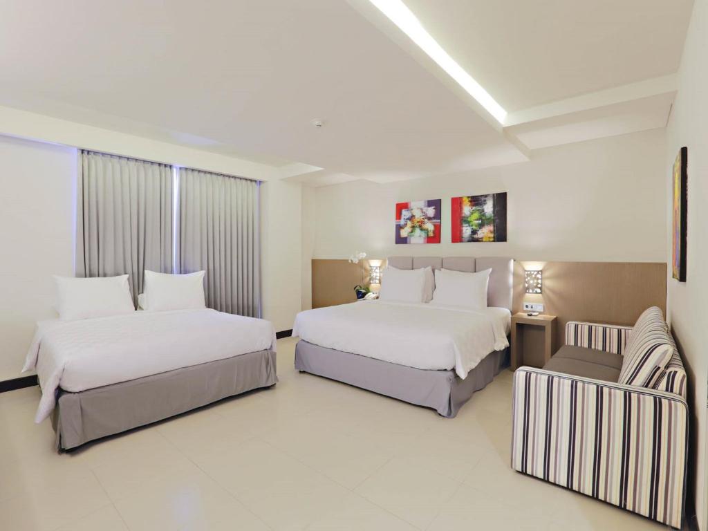 Postel nebo postele na pokoji v ubytování Euphoria Hotel